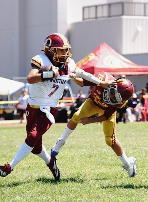 Aaron Lomas (pictured on left) playing for Whittier as quarterback.